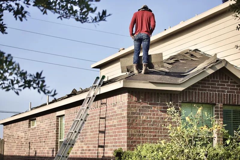 Professional roofer working on a residential roof in Fulton Run